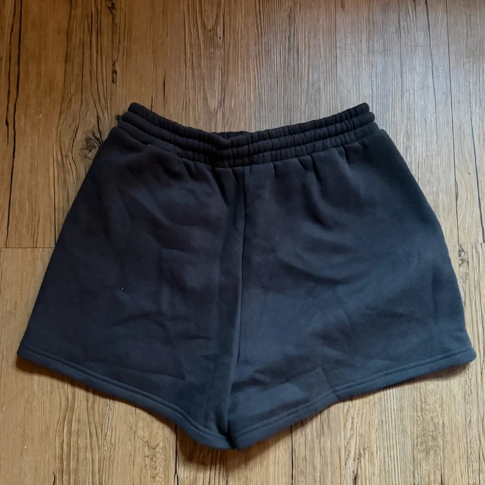 White Fox Boutique charcoal shorts with white text reading 'WHITE FOX VOL.3'